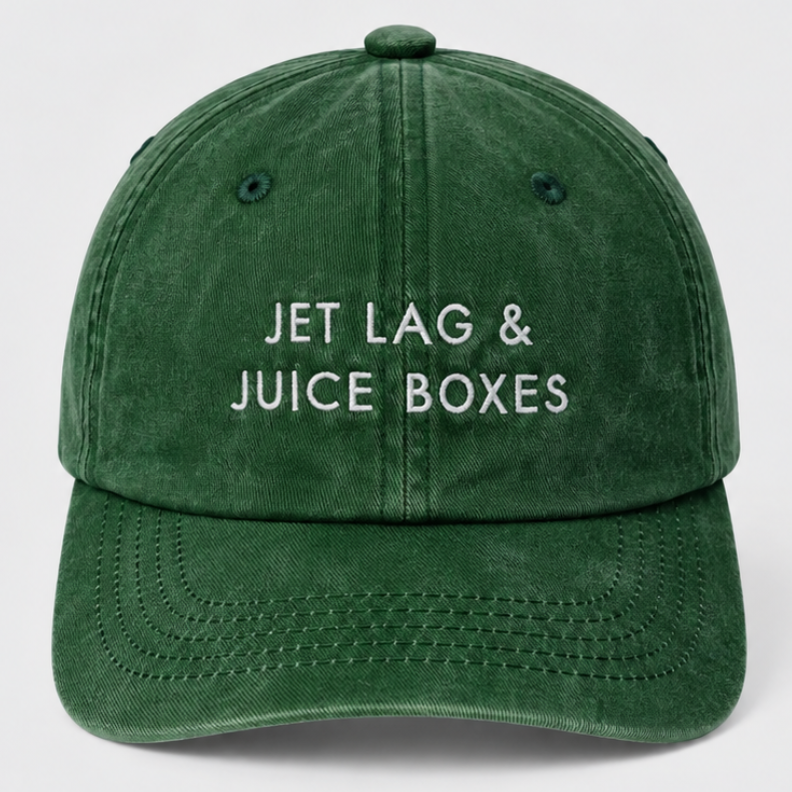 green washed cotton relaxed fit cap with jetlag and juice boxes slogan